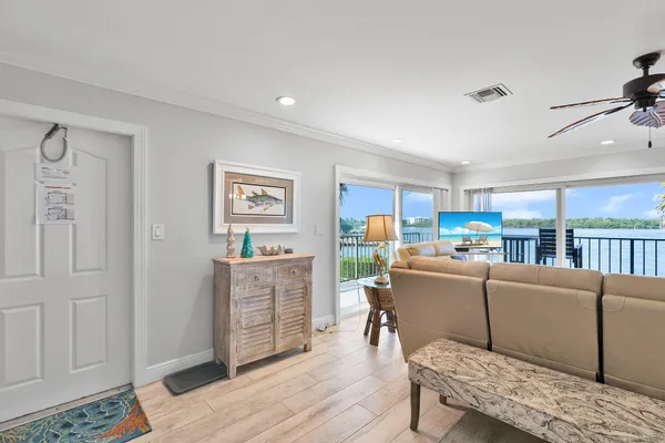 a living room with furniture and a wooden floor
