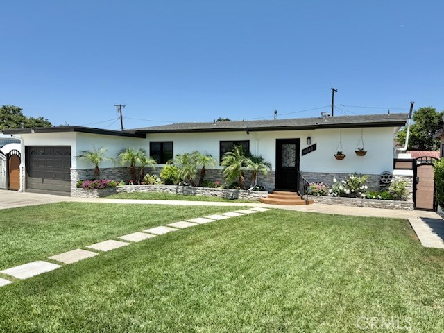 13302 Sandra Place Garden Grove, CA 92843 - Photo 2 of 41 a front view of a house with garden