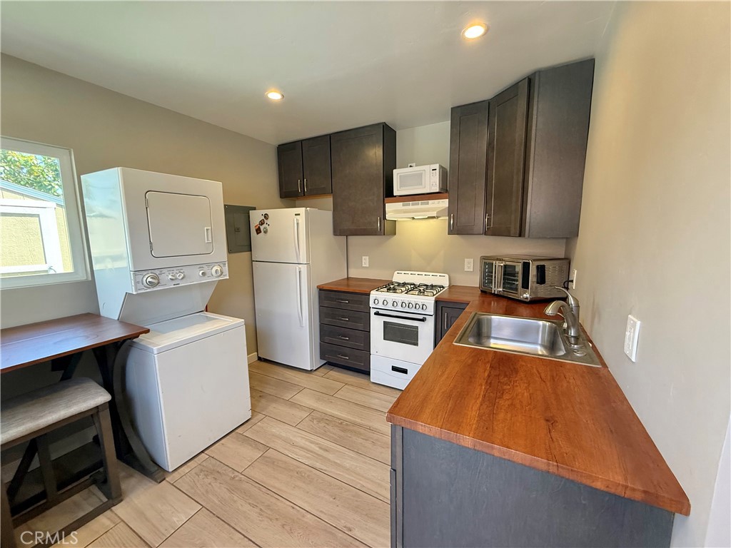 13302 Sandra Place Garden Grove, CA 92843 - Photo 36 of 41 a kitchen with white cabinets and stainless steel appliances