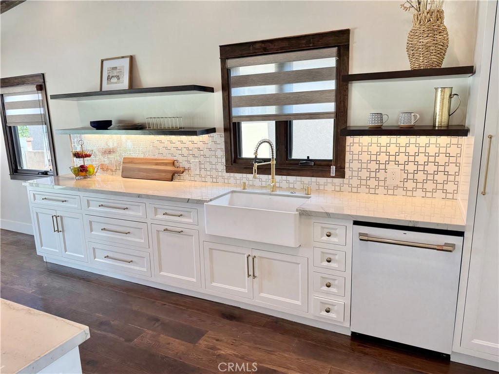 13302 Sandra Place Garden Grove, CA 92843 - Photo 10 of 41 a kitchen with granite countertop white cabinets and window
