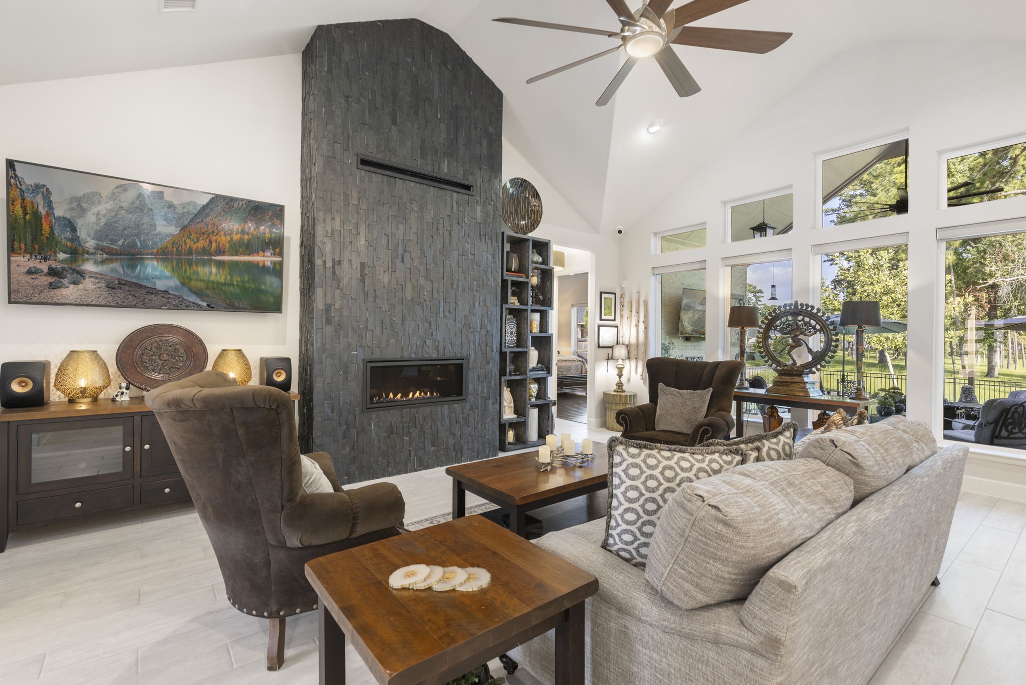 15423 Ringbill Way Magnolia, TX 77354 - Photo 12 of 50 a living room with furniture a flat screen tv and a floor to ceiling window