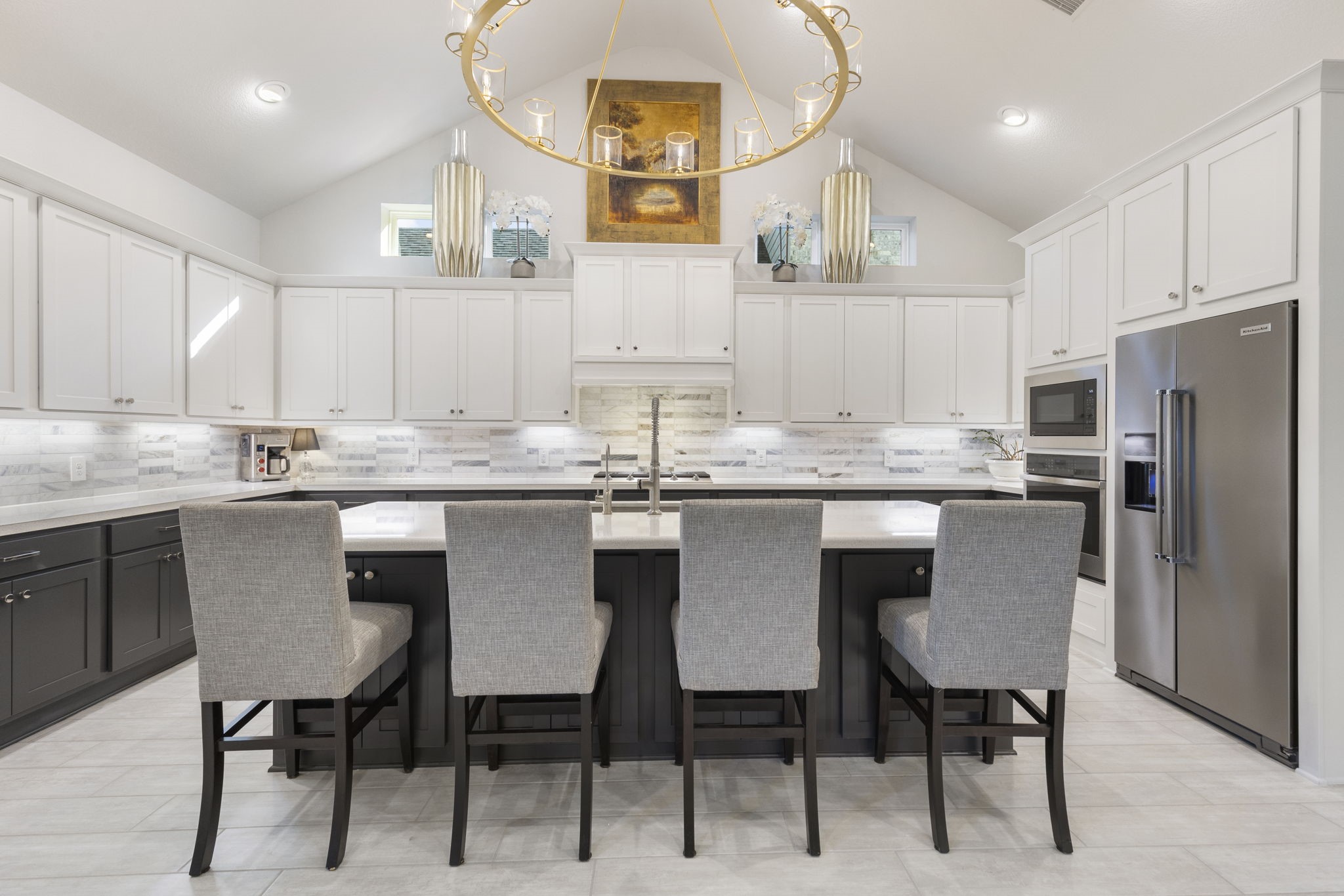 15423 Ringbill Way Magnolia, TX 77354 - Photo 17 of 50 a kitchen with stainless steel appliances kitchen island granite countertop a table chairs and a refrigerator