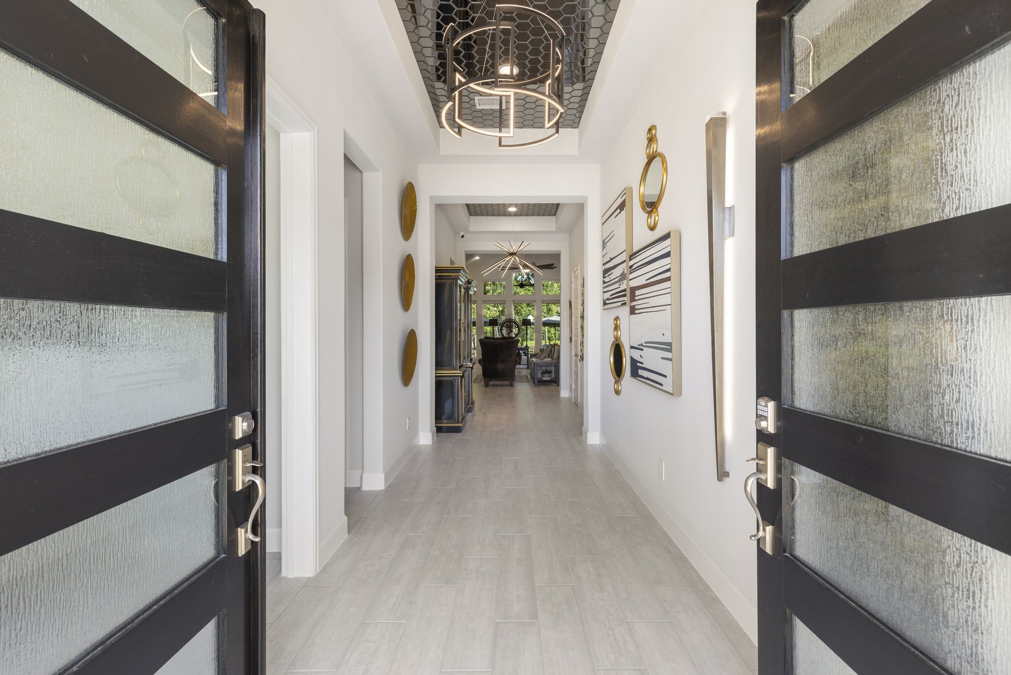 15423 Ringbill Way Magnolia, TX 77354 - Photo 6 of 50 a view of a hallway with a dining area with chandelier