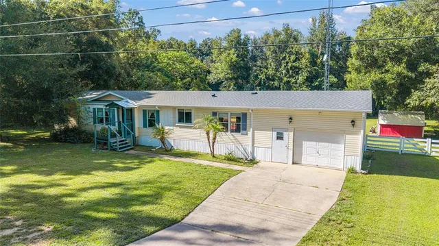 a view of house with outdoor space and seating area