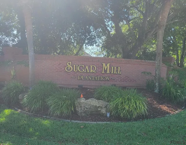 a view of a park that has sign on the side of the road