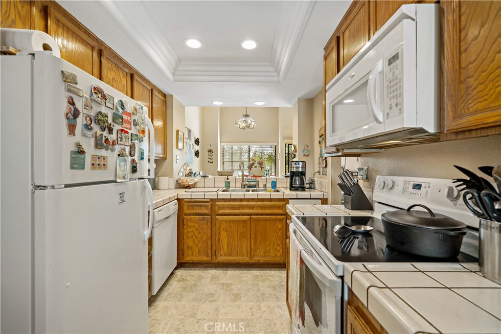 1514 Apache Drive, Unit E Chula Vista, CA 91910 - Photo 17 of 43 a kitchen with stainless steel appliances a sink a stove a refrigerator and cabinets