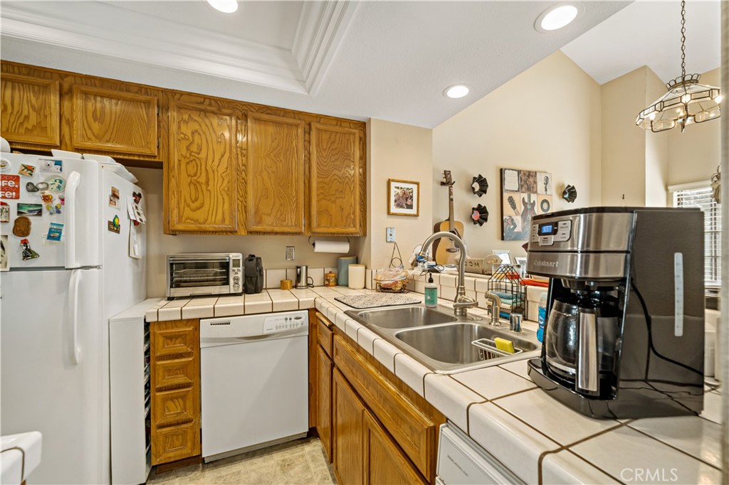1514 Apache Drive, Unit E Chula Vista, CA 91910 - Photo 19 of 43 a kitchen with a sink a refrigerator and cabinets