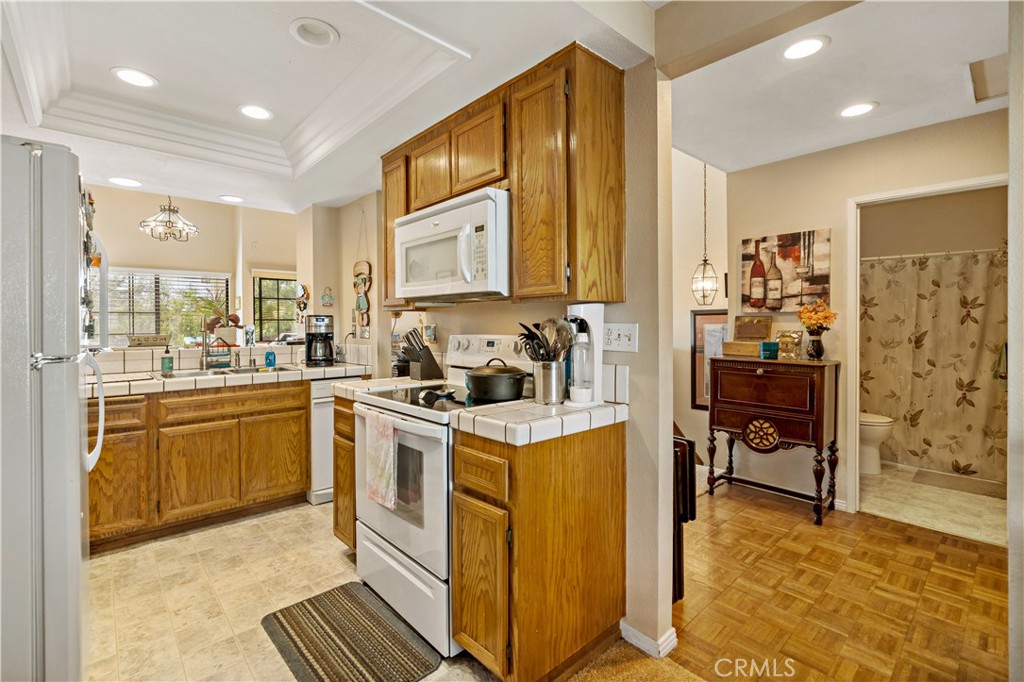 1514 Apache Drive, Unit E Chula Vista, CA 91910 - Photo 22 of 43 a kitchen with a stove a refrigerator and a sink