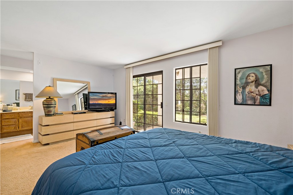 1514 Apache Drive, Unit E Chula Vista, CA 91910 - Photo 28 of 43 a bedroom with a large bed and a chandelier