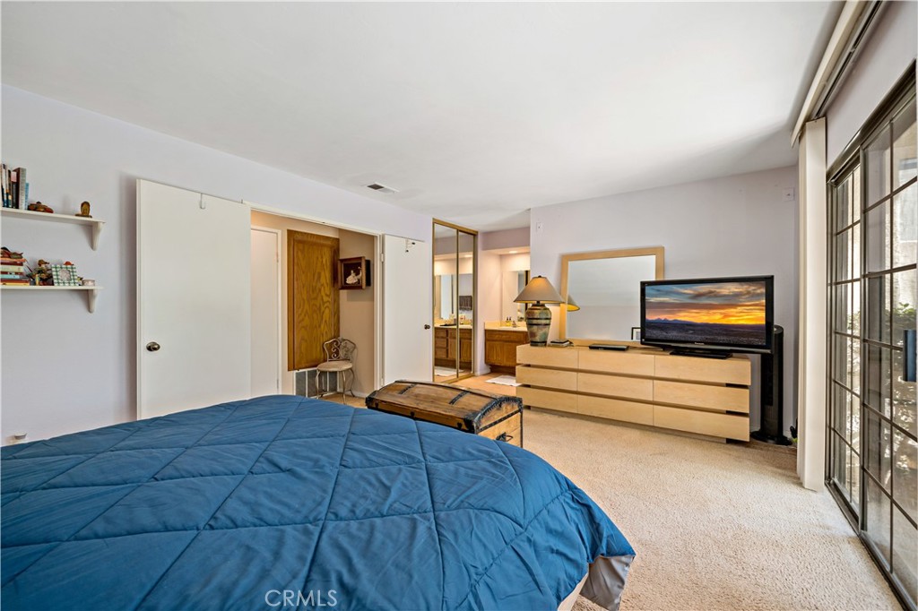 1514 Apache Drive, Unit E Chula Vista, CA 91910 - Photo 30 of 43 a bedroom with a bed and a view of walk in closet