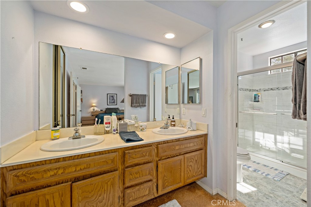 1514 Apache Drive, Unit E Chula Vista, CA 91910 - Photo 31 of 43 a bathroom with double vanity sinks double vanity tub shower and a mirror