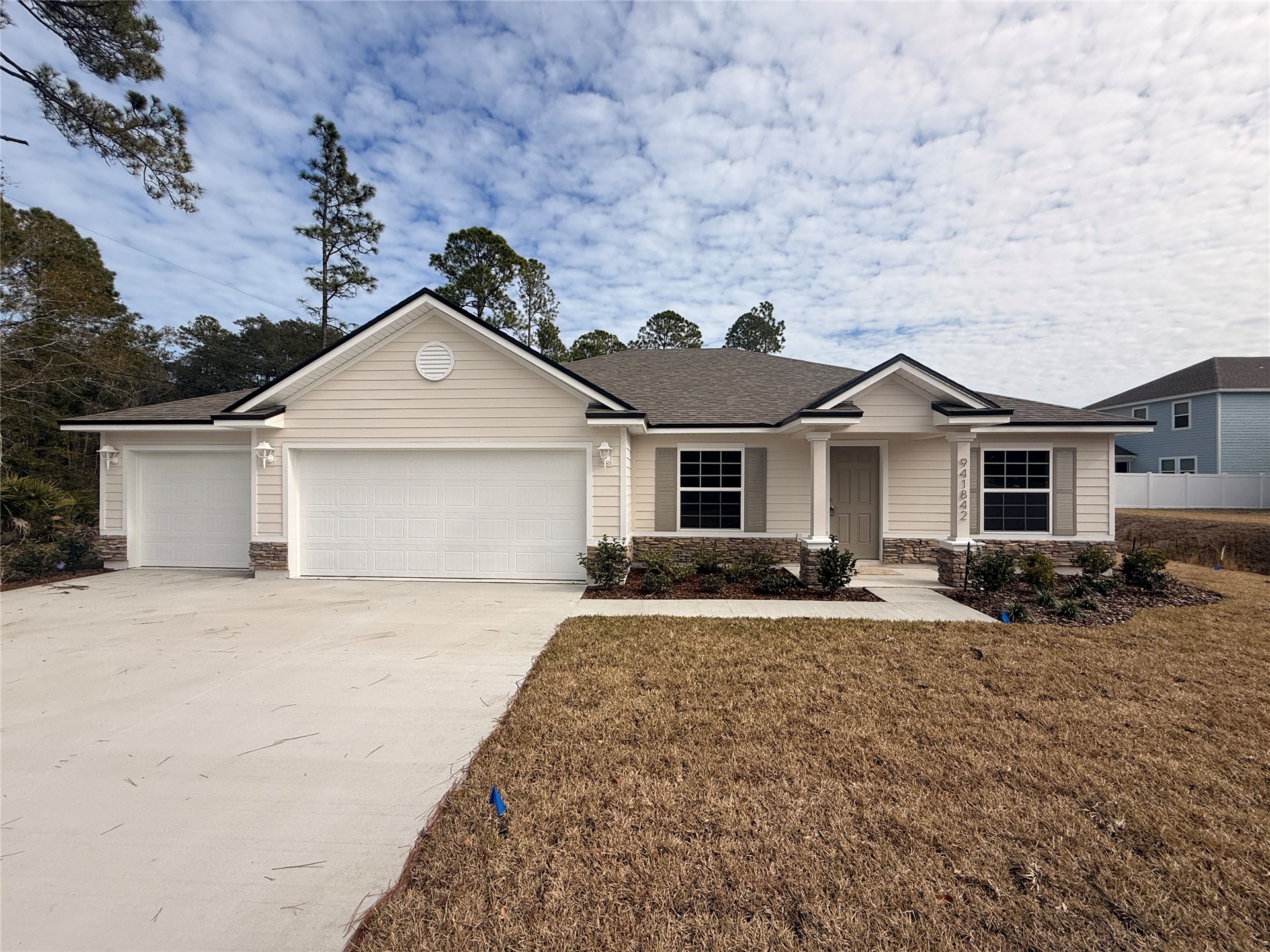 941842 Old Nassauville Road Fernandina Beach, FL 32034 - Photo 1 of 14 a front view of a house with a yard and garage