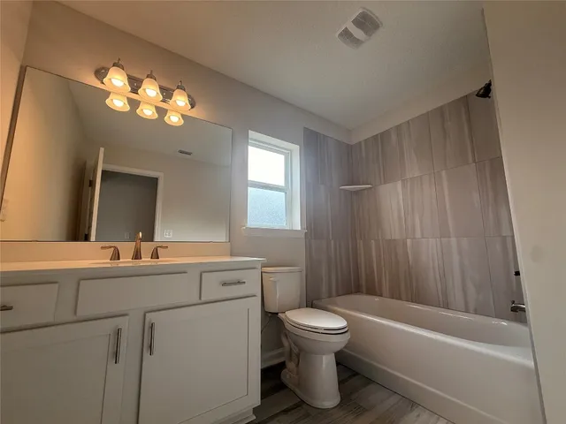 a bathroom with a sink a toilet and a bathtub