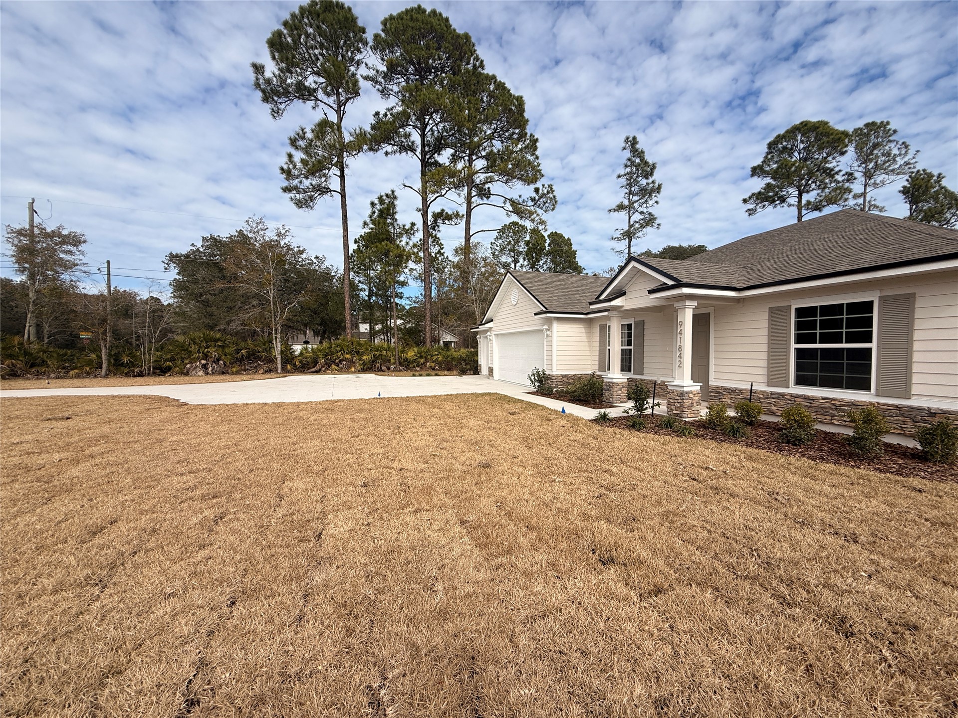 941842 Old Nassauville Road Fernandina Beach, FL 32034 - Photo 3 of 14 a view of a house with a yard