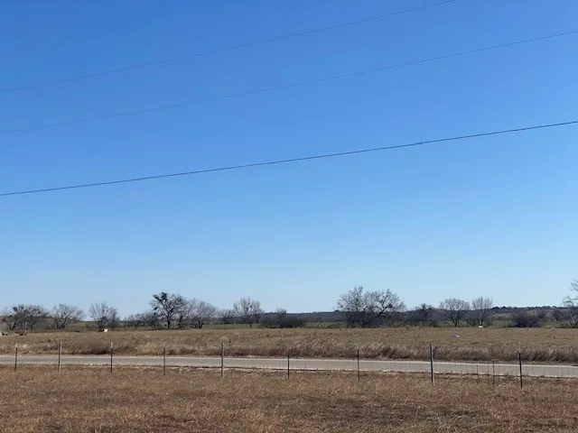 a view of a field and trees