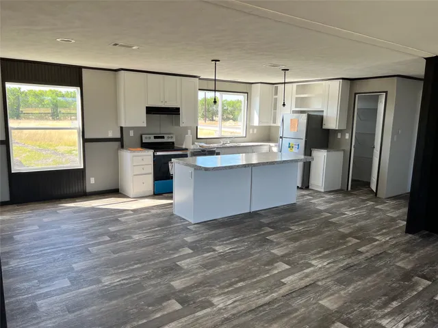 a kitchen with stainless steel appliances a refrigerator sink and microwave