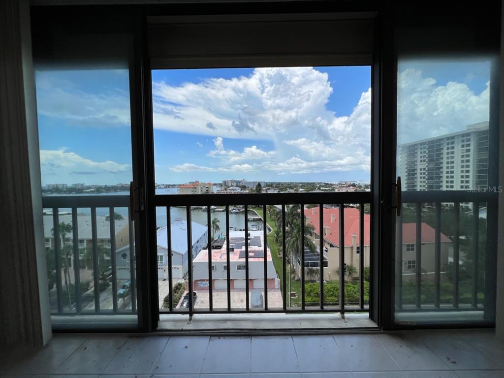 255 Dolphin Point, Unit 809 Clearwater, FL 33767 - Photo 15 of 42 a view of a glass door with a yard from a window