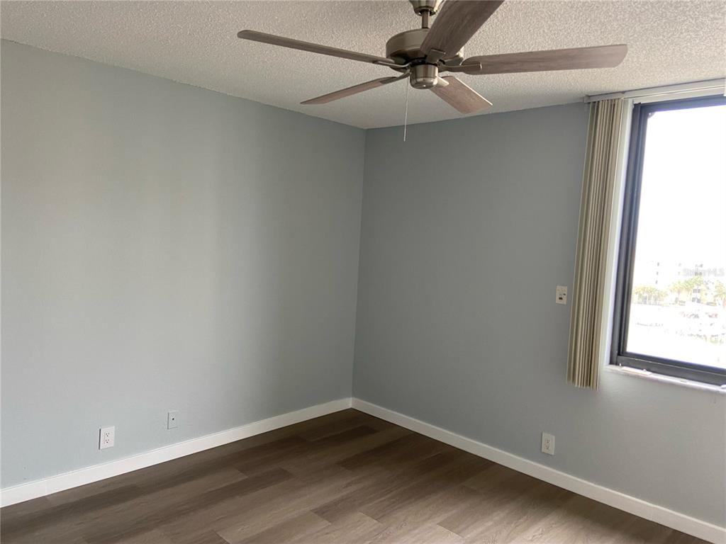 255 Dolphin Point, Unit 809 Clearwater, FL 33767 - Photo 10 of 42 an empty room with a window and a fan