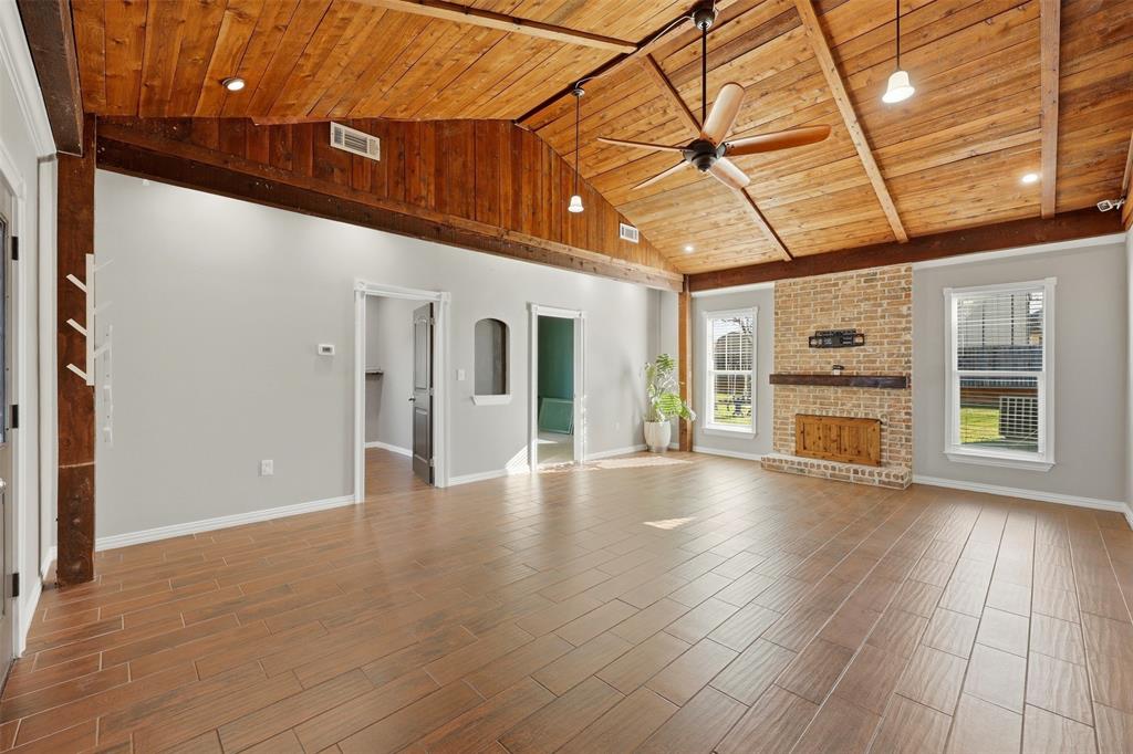 113 Mulkey Road Waxahachie, TX 75167 - Photo 12 of 39 a view of an empty room with a window and wooden floor