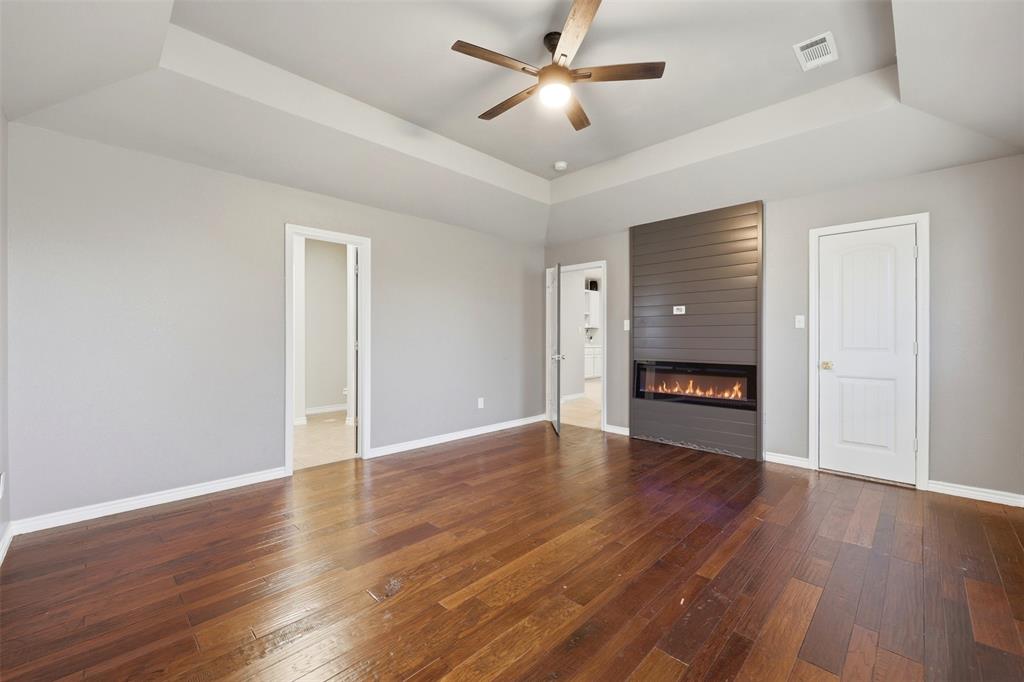 113 Mulkey Road Waxahachie, TX 75167 - Photo 13 of 39 a view of an empty room with a window and wooden floor