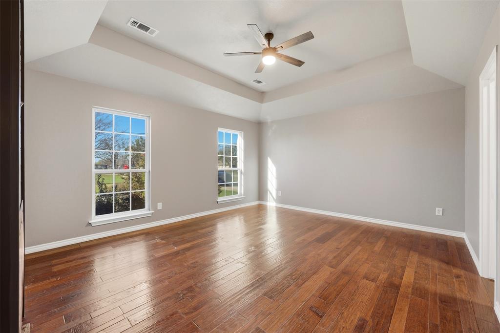 113 Mulkey Road Waxahachie, TX 75167 - Photo 14 of 39 wooden floor in an empty room with a window