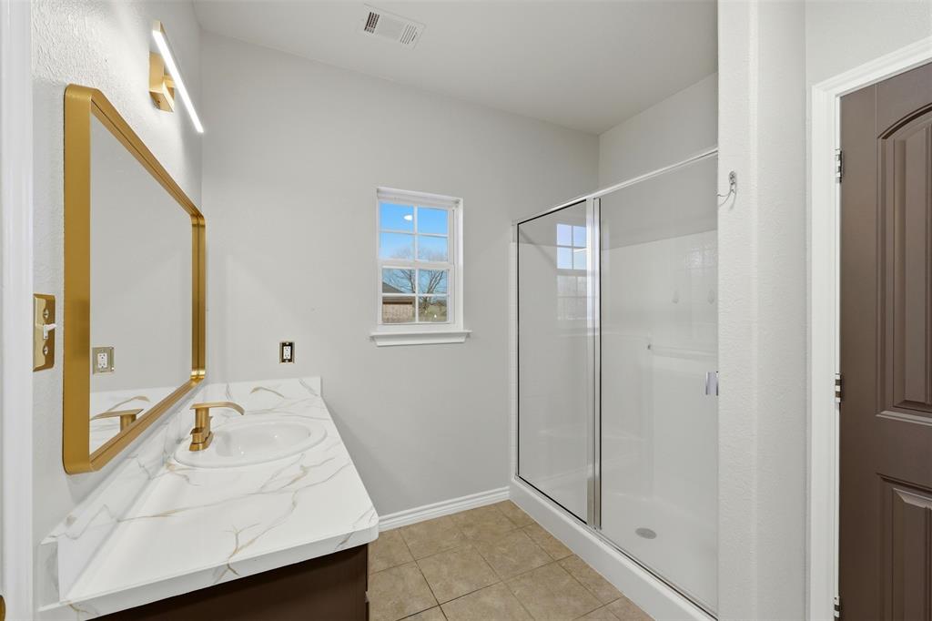 113 Mulkey Road Waxahachie, TX 75167 - Photo 15 of 39 a bathroom with a sink and shower