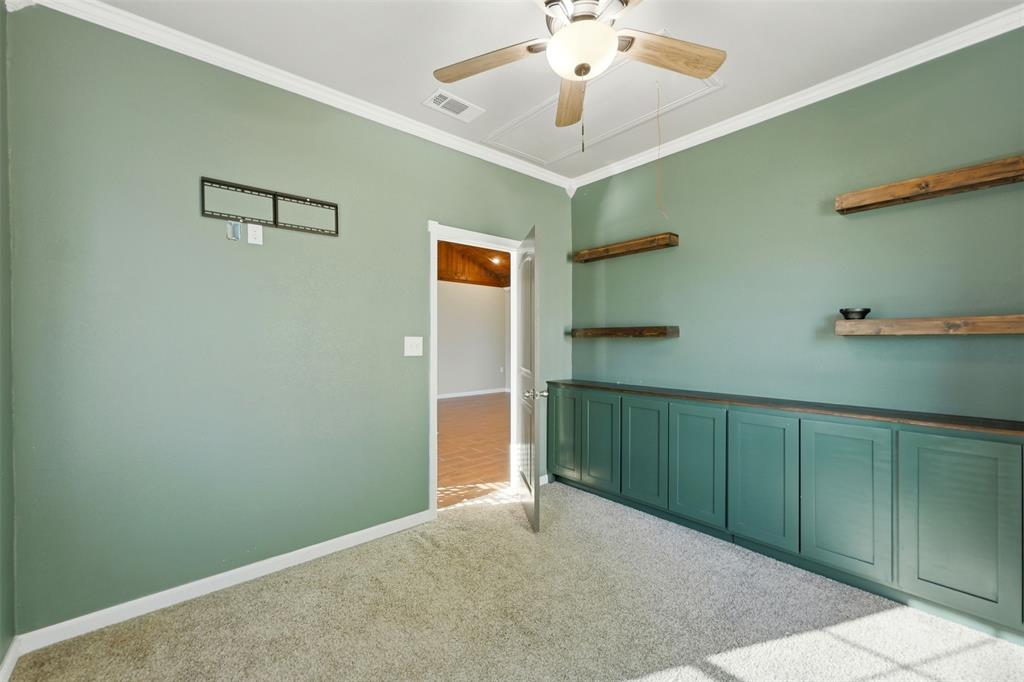 113 Mulkey Road Waxahachie, TX 75167 - Photo 16 of 39 a view of a hallway with a chandelier fan