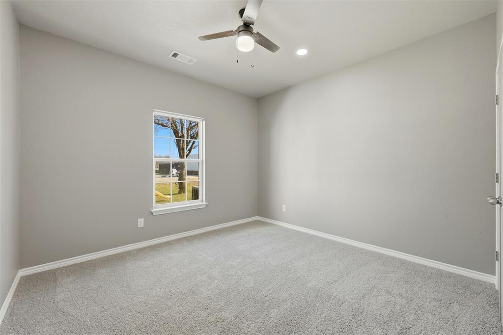 113 Mulkey Road Waxahachie, TX 75167 - Photo 17 of 39 an empty room with a window and ceiling fan