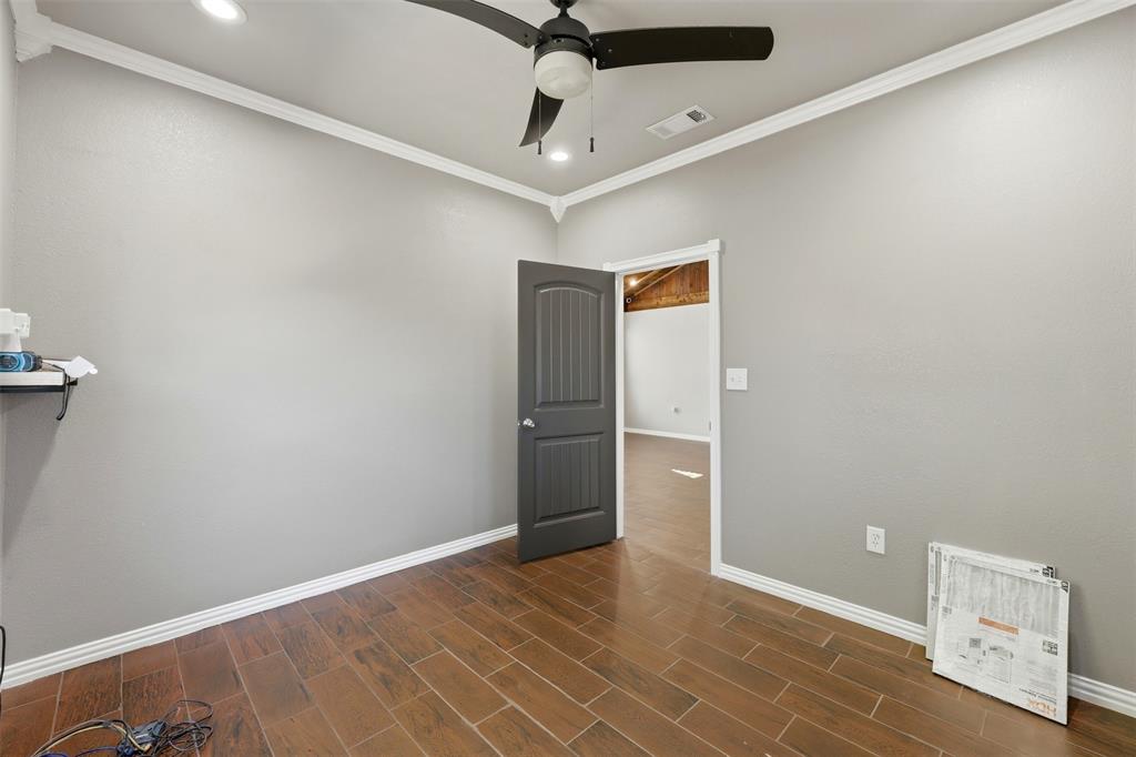 113 Mulkey Road Waxahachie, TX 75167 - Photo 18 of 39 an empty room with a ceiling fan and wooden floor