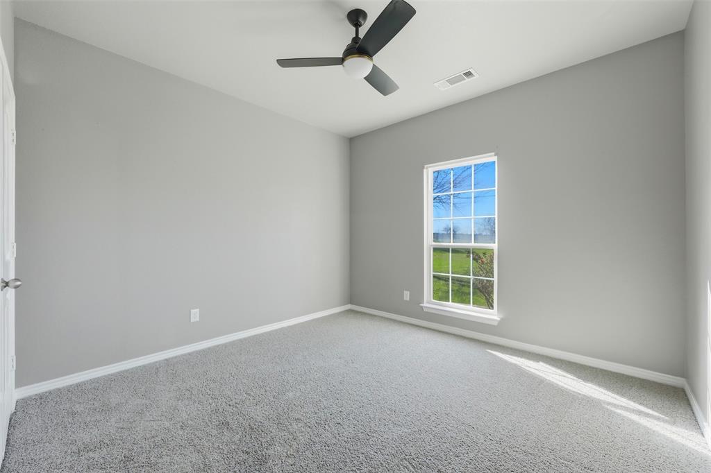 113 Mulkey Road Waxahachie, TX 75167 - Photo 20 of 39 an empty room with a window and a fan
