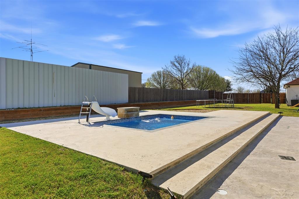 113 Mulkey Road Waxahachie, TX 75167 - Photo 32 of 39 a view of a swimming pool with an outdoor space and seating area