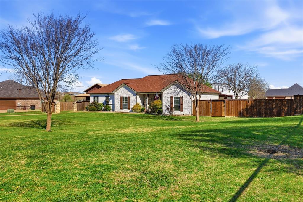 113 Mulkey Road Waxahachie, TX 75167 - Photo 39 of 39 a view of a white house in front of a big yard with large trees