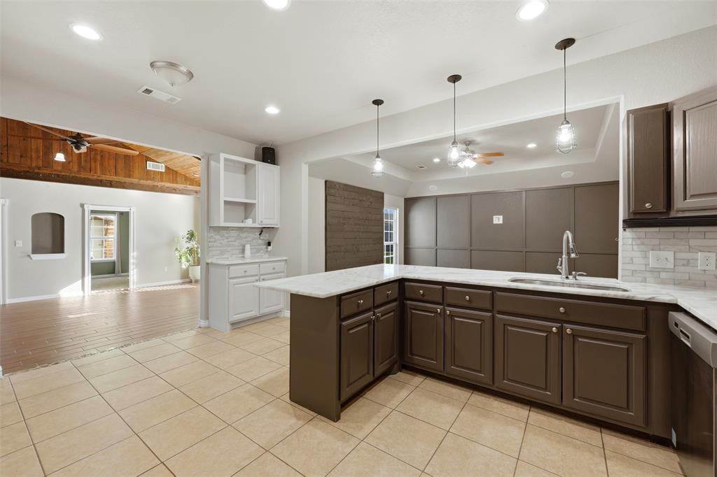 113 Mulkey Road Waxahachie, TX 75167 - Photo 9 of 39 a large kitchen with kitchen island a sink stainless steel appliances and cabinets