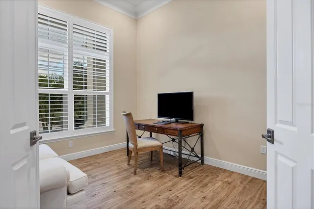 a view of a workspace with furniture and a window