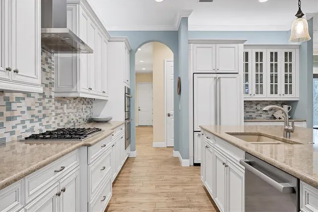 a kitchen with granite countertop a sink stove and cabinets