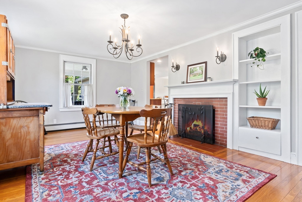 94 Conant Street Danvers, MA 01923 - Photo 16 of 36 a dining room with furniture a rug and a fireplace