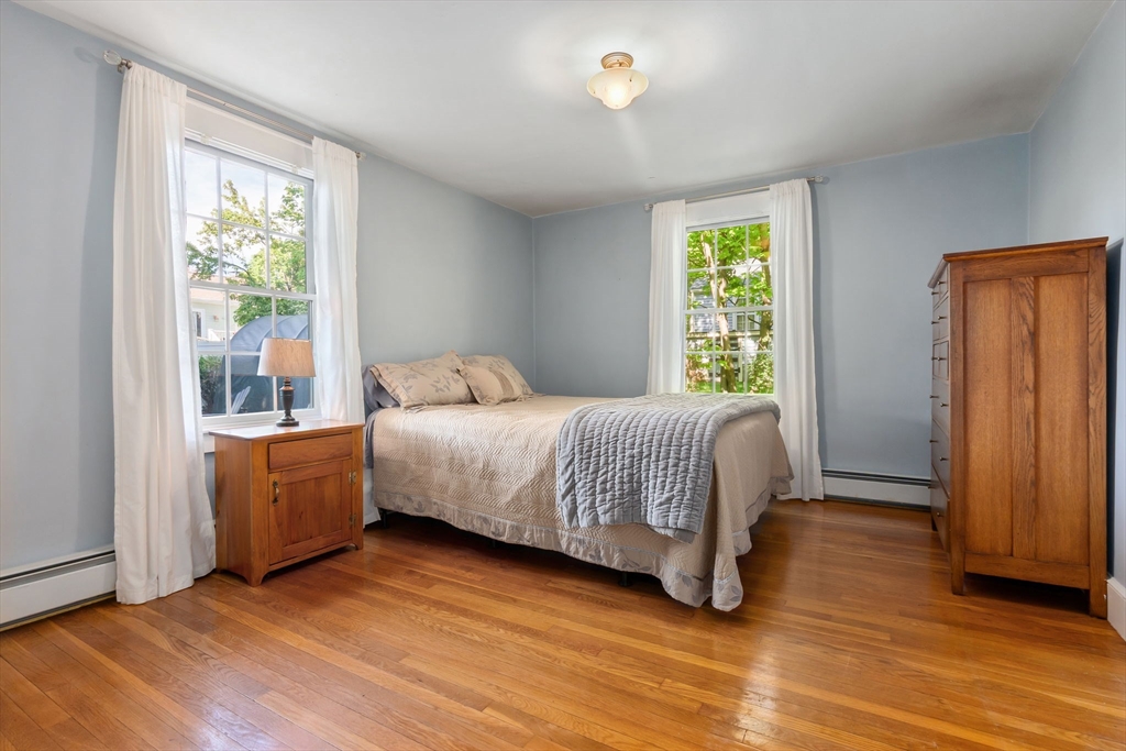 94 Conant Street Danvers, MA 01923 - Photo 20 of 36 a bedroom with a bed and wooden floor