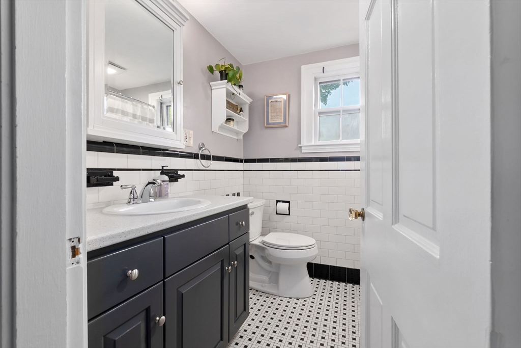 94 Conant Street Danvers, MA 01923 - Photo 23 of 36 a bathroom with a sink toilet a mirror and vanity