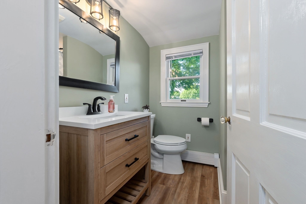 94 Conant Street Danvers, MA 01923 - Photo 26 of 36 a bathroom with a sink toilet a mirror and window