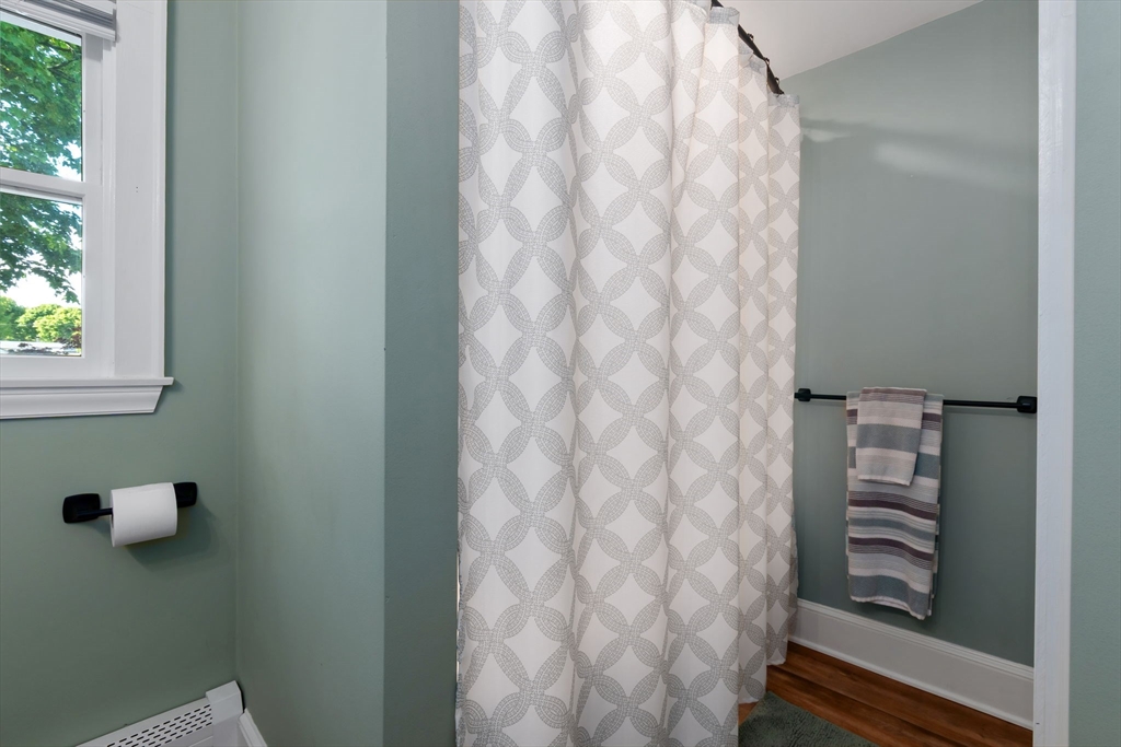 94 Conant Street Danvers, MA 01923 - Photo 27 of 36 a bathroom with a shower curtain and a window