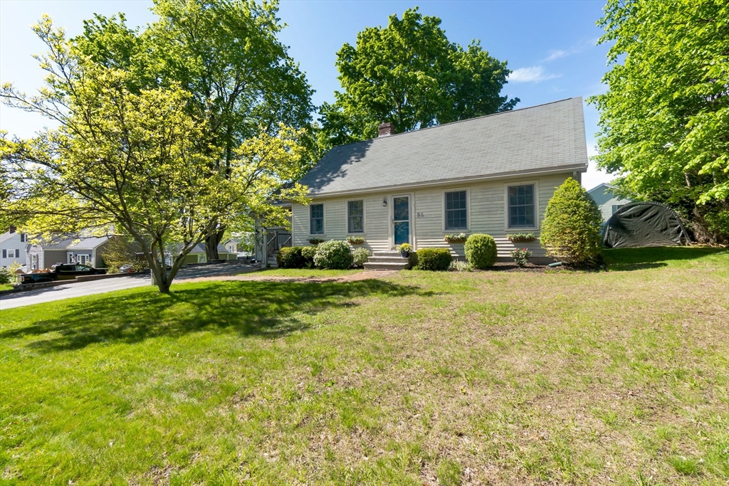94 Conant Street Danvers, MA 01923 - Photo 3 of 36 a backyard of a house with garden and trees