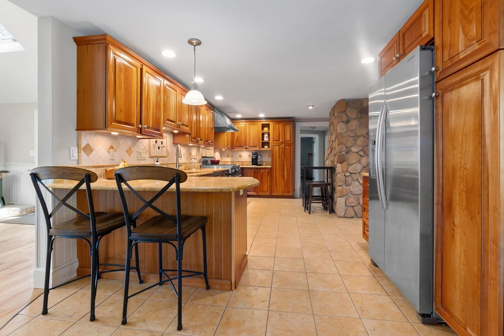 94 Conant Street Danvers, MA 01923 - Photo 9 of 36 a kitchen with stainless steel appliances kitchen island granite countertop a refrigerator and a sink
