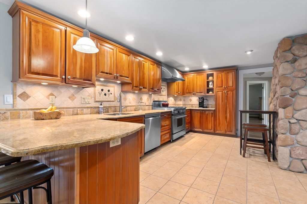 94 Conant Street Danvers, MA 01923 - Photo 10 of 36 a kitchen with stainless steel appliances granite countertop a stove sink and cabinets