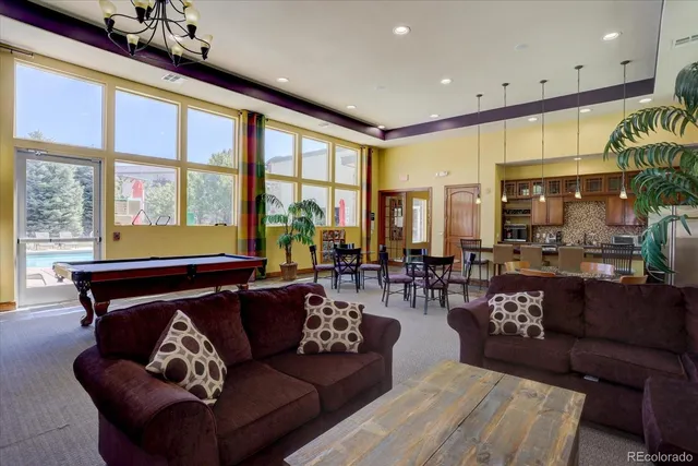 a view of a house with swimming pool and sitting area