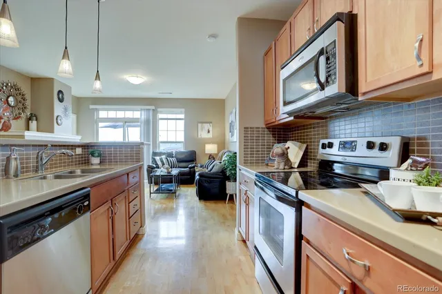 a kitchen with a stove a sink and a refrigerator