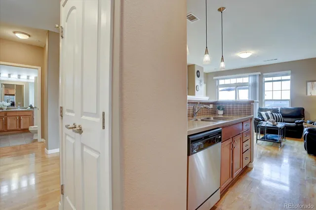 a view of a kitchen with a sink and wooden floor
