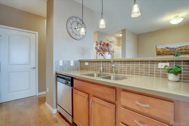 a kitchen with stainless steel appliances a stove microwave and sink