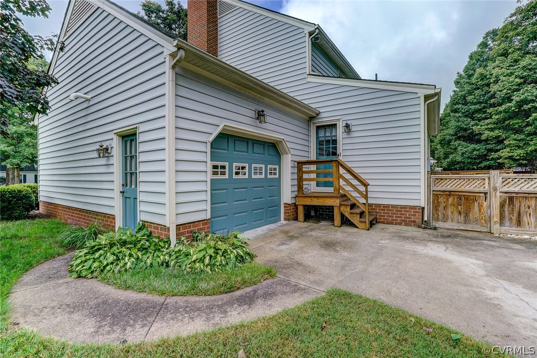 6100 Springwood Road Chester, VA 23831 - Photo 23 of 25 a view of a house with a yard and a garage