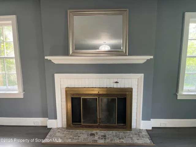 a view of a hallway with wooden floor and stairs