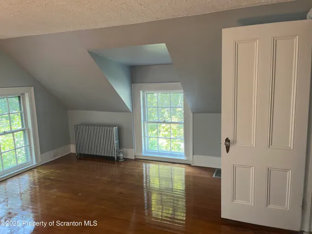 a view of an entryway with wooden floor